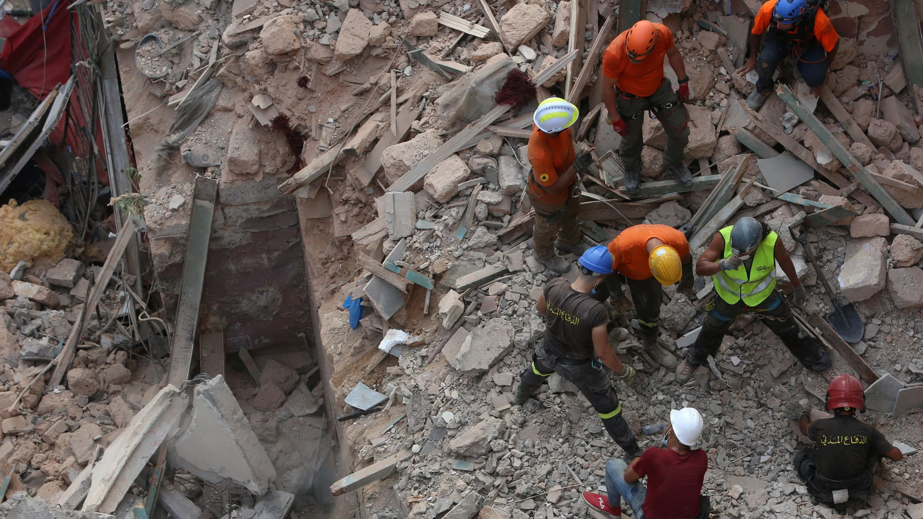 Rescue team search through rubble of buildings damaged due to the massive explosion at Beirut's port area