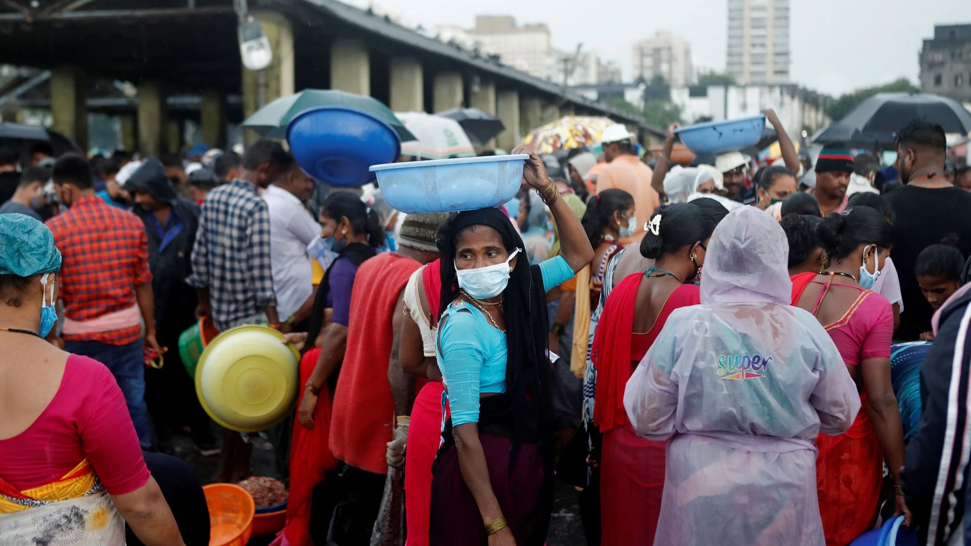 A fisherwoman wearing a protective mask is seen at a fish market amidst the spread of the coronavirus disease (COVID-19) in Mumbai