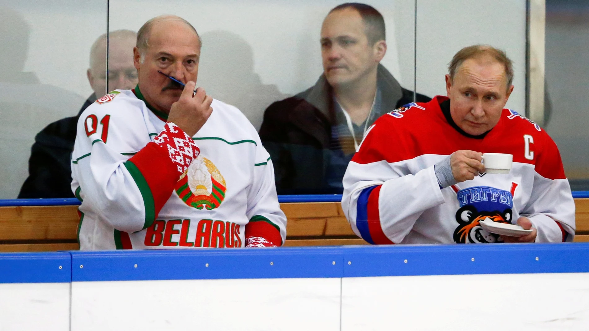 FILE PHOTO: FILE PHOTO: Russian President Vladimir Putin and Belarusian President Alexander Lukashenko take a break during a match of the Night Hockey League teams in Rosa Khutor in the Black Sea resort of Sochi
