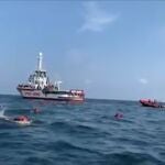 Migrants swim away from Spanish rescue ship Open Arms after more than 70 of them jumped from the ship to attempt to reach the coast, at sea near Palermo, Italy, in this still image taken from video, September 17, 2020. Open Arms/ Handout via REUTERS ATTENTION EDITORS - THIS PICTURE WAS PROVIDED BY A THIRD PARTY. BEST QUALITY AVAILABLE