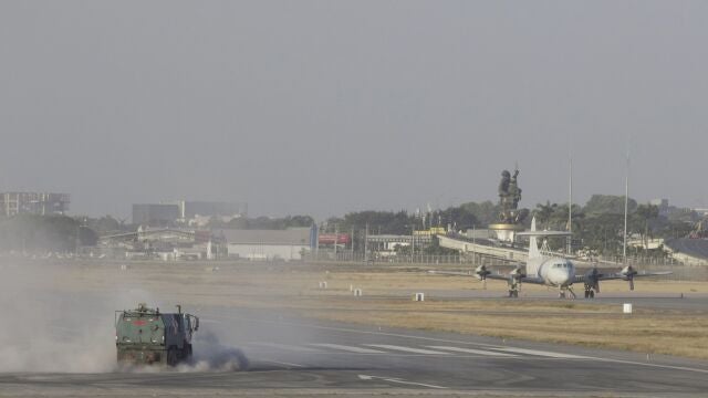 A street sweeper truck clears volcanic ash from the runway of the Jose Joaquin de Olmedo international airport in Guayaquil, Ecuador, Sunday, Sept. 20, 2020. An intense volcanic ash fall was registered in various parts of Ecuador due to an eruption of Sangay Volcano, located in the Amazon area of the country. (AP Photo/Angel Dejesus)