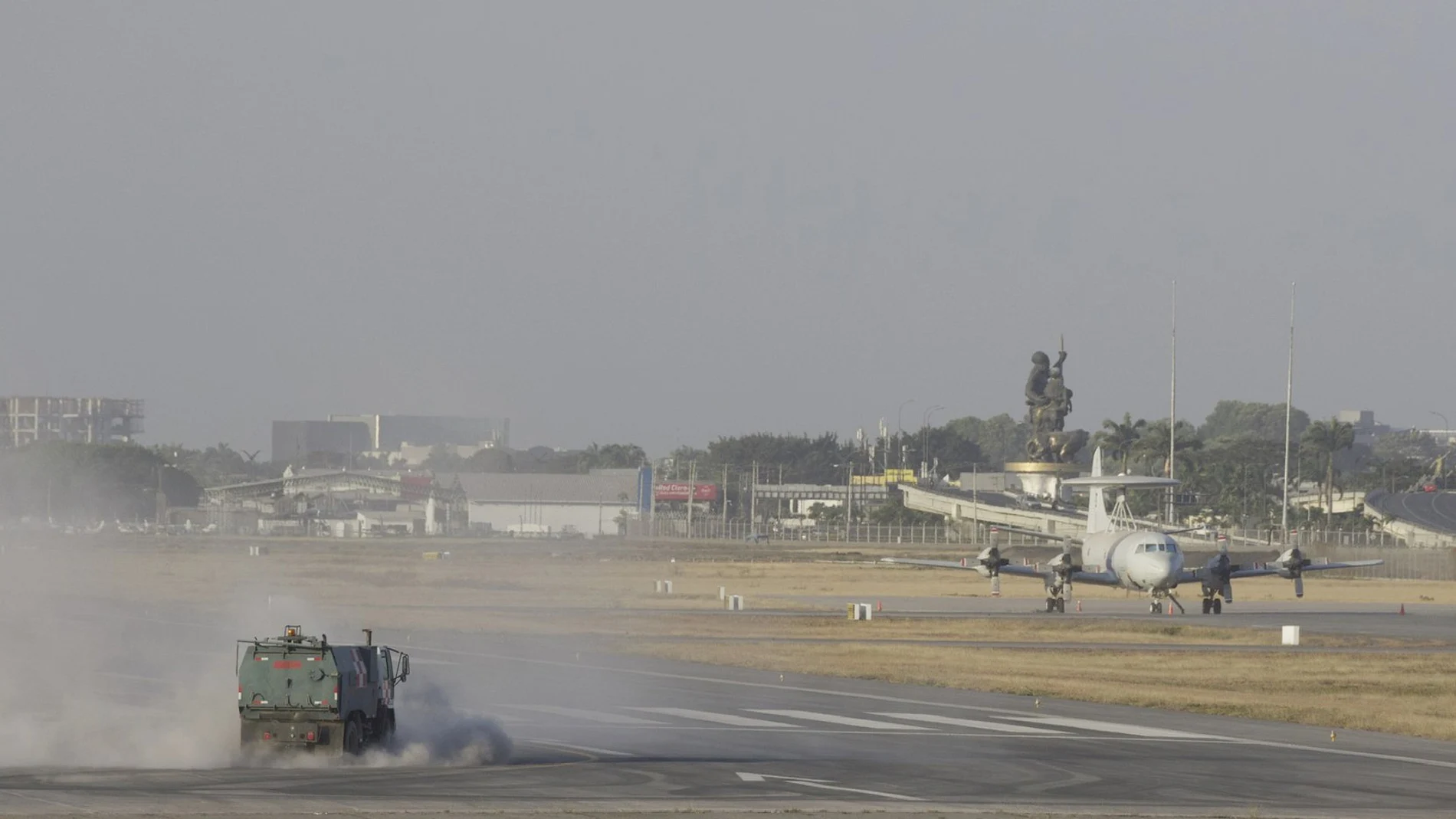 A street sweeper truck clears volcanic ash from the runway of the Jose Joaquin de Olmedo international airport in Guayaquil, Ecuador, Sunday, Sept. 20, 2020. An intense volcanic ash fall was registered in various parts of Ecuador due to an eruption of Sangay Volcano, located in the Amazon area of the country. (AP Photo/Angel Dejesus)
