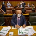 El consejero de Salud y Familias, Jesús Aguirre (c), en su escaño rodeado de informes al inicio de la sesión de control al Ejecutivo hoy en el Parlamento de Andalucía en Sevilla