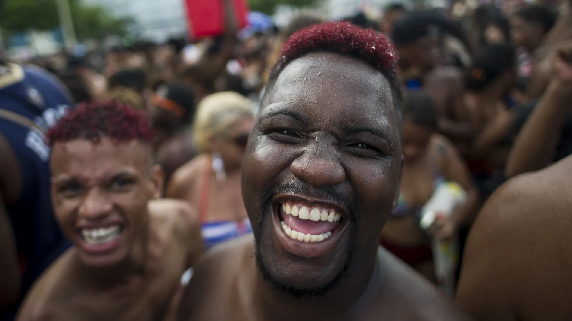 FILE - in this Jan. 12, 2020 file photo, revelers smile as they look on the camera during the "Bloco da Favorita" street party on Copacabana beach, Rio de Janeiro, Brazil. The city announced on Thursday, Sept. 24, said it has delayed its annual Carnival parade, saying the global spectacle cannot go ahead in February because of Brazilâ€™s continued vulnerability to the new coronavirus pandemic, but has yet to announce a decision about the Carnival street parties that take place across the city. (AP Photo/Bruna Prado, File)
