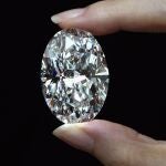 A 102.39 carat, D color, flawless diamond is displayed by a model at a Sothebyâ€™s auction room in Hong Kong Monday, Sept. 28, 2020. It is the first time that a diamond this size and caliber will be auctioned without reservations in history. (AP Photo/Vincent Yu)
