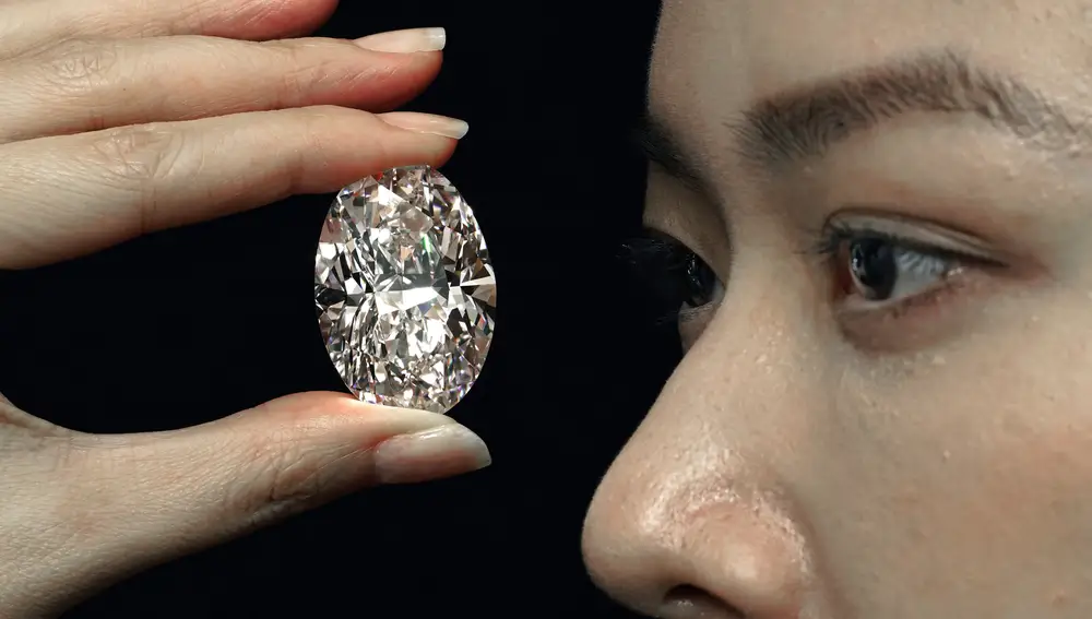 A 102.39 carat, D color, flawless diamond is displayed by a model at a Sothebyâ€™s auction room in Hong Kong Monday, Sept. 28, 2020. It is the first time that a diamond this size and caliber will be auctioned without reservations in history. (AP Photo/Vincent Yu)