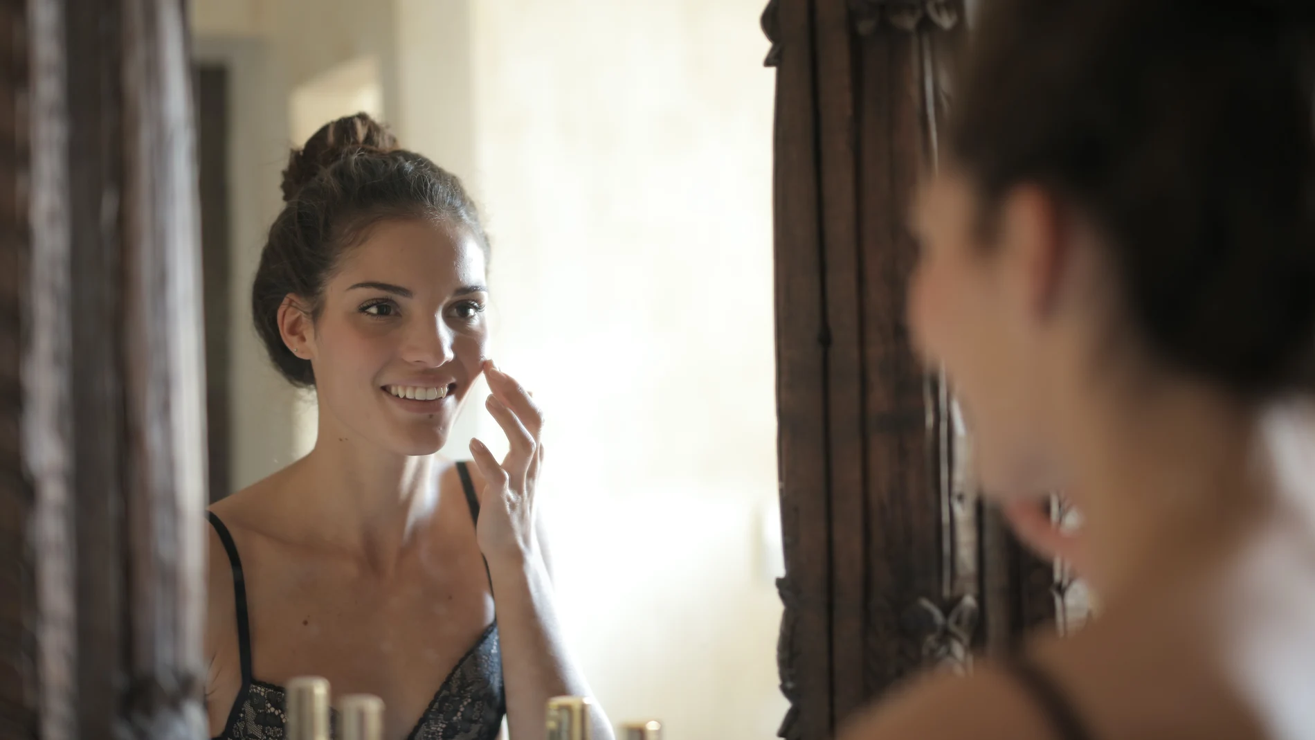 En la imagen, una mujer se aplica sus cosméticos antes de dormir.