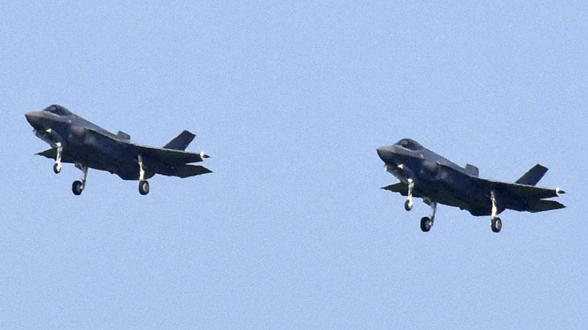 FILE - In this Aug. 1, 2019, file photo, Japanese Air Self-Defense Force's F-35A stealth fighter jets prepare to land at Misawa Air Base in Misawa, northern Japan. Japan's Defense Ministry is seeking a record-high budget of nearly 5.5 trillion yen ($55 billion) for fiscal 2021 fund more purchases of costly American stealth fighters and expand its capability to counter possible threats in both cyber and outer space.(Kyodo News via AP, File)