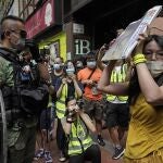 Una manifestante muestra el periódico que pide la liberación de los doce hongkoneses detenidos por la China continental al intentar escapar a Taiwán
