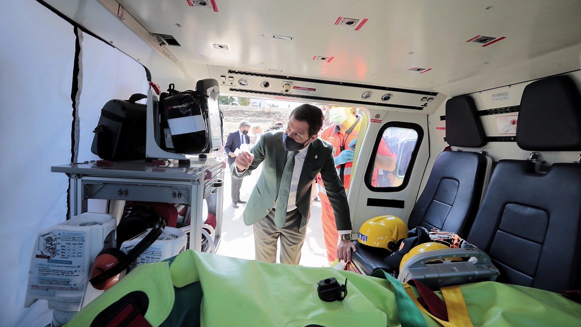 l presidente de la Junta de Andalucía, Juanma Moreno, observa el interior de un helicóptero medicalizado que prestará servicio en el hospital de Jerez de la Frontera (Cádiz), durante el acto de presentación hoy en el helipuerto del centro hospitalario. EFE/Román Ríos.
