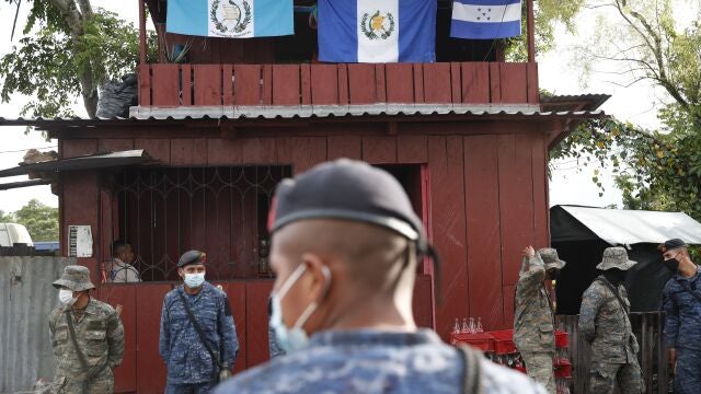 Soldiers stand in El Cinchado, Guatemala, on the border with Honduras, Friday, Oct. 2, 2020. Guatemala vowed to detain and return members of a new caravan of about 2,000 migrants that set out from neighboring Honduras in hopes of reaching the United States, saying they represent a health threat amid the coronavirus pandemic. (AP Photo/Moises Castillo)