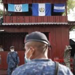 Soldiers stand in El Cinchado, Guatemala, on the border with Honduras, Friday, Oct. 2, 2020. Guatemala vowed to detain and return members of a new caravan of about 2,000 migrants that set out from neighboring Honduras in hopes of reaching the United States, saying they represent a health threat amid the coronavirus pandemic. (AP Photo/Moises Castillo)