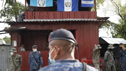 Soldiers stand in El Cinchado, Guatemala, on the border with Honduras, Friday, Oct. 2, 2020. Guatemala vowed to detain and return members of a new caravan of about 2,000 migrants that set out from neighboring Honduras in hopes of reaching the United States, saying they represent a health threat amid the coronavirus pandemic. (AP Photo/Moises Castillo)