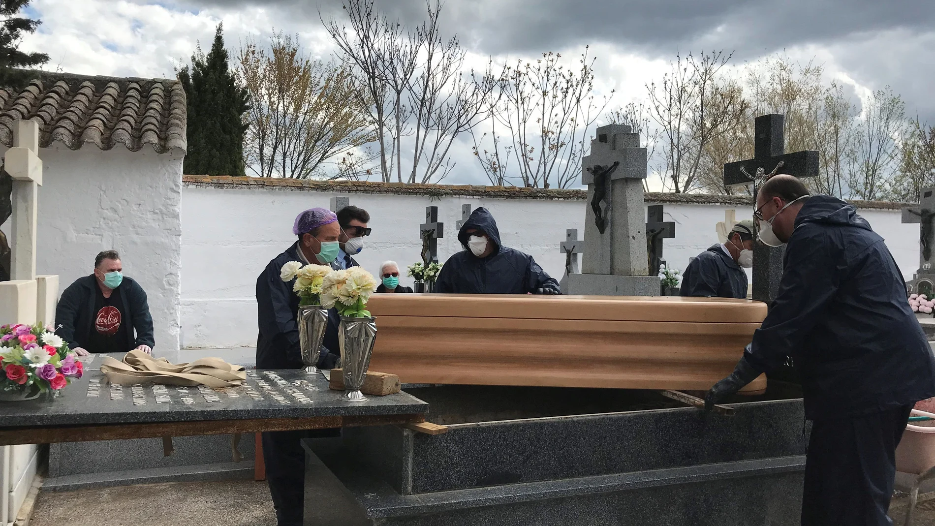 Operarios proceden a enterrar un féretro en el cementerio de Aldea del Rey, Ciudad Real