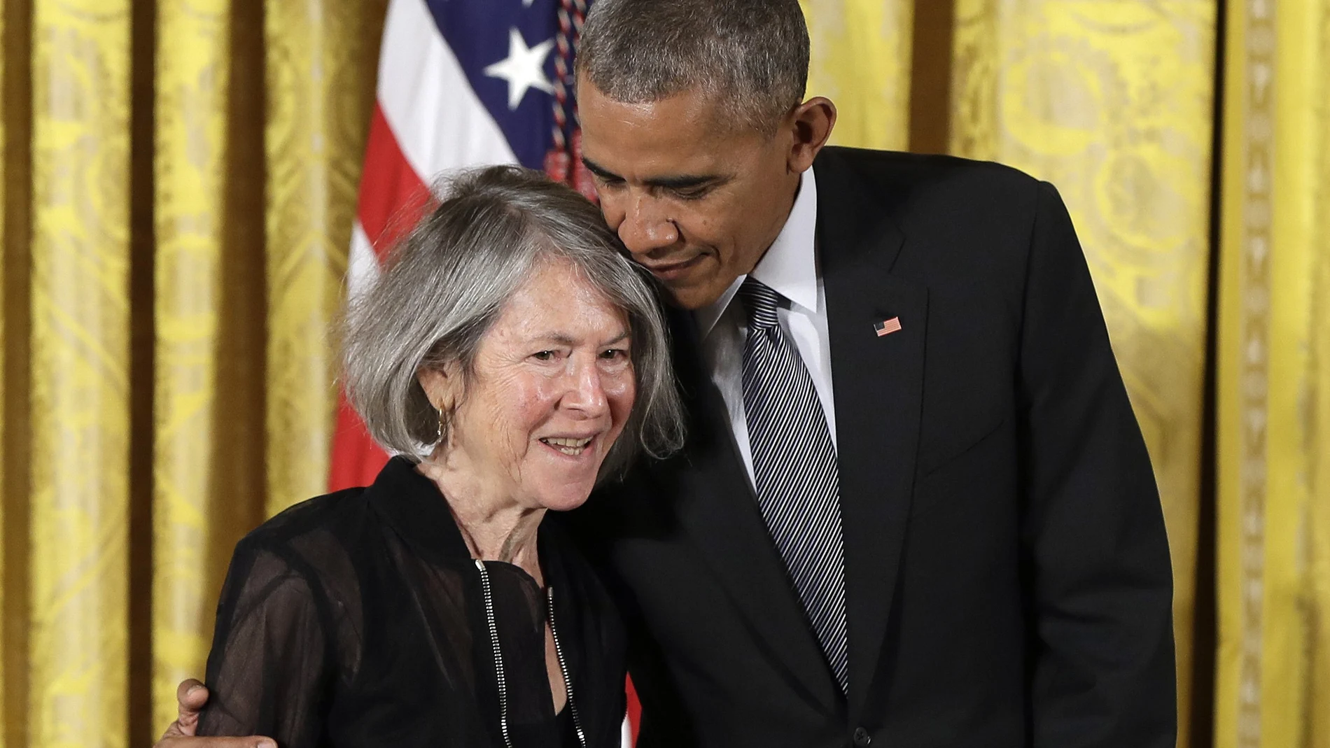FILE - In this Thursday, Sept. 22, 2016 file photo, President Barack Obama embraces poet Louise Gluck before awarding her the 2015 National Humanities Medal during a ceremony in the East Room of the White House, in Washington. The 2020 Nobel Prize for literature has been awarded to American poet Louise Gluck â€œfor her unmistakable poetic voice that with austere beauty makes individual existence universal.â€ The prize was announced Thursday Oct. 8, 2020 in Stockholm by Mats Malm, the permanent secretary of the Swedish Academy. (AP Photo/Carolyn Kaster, File)