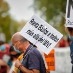 Un hombre sostiene un cartel en el que se lee "Renta Básica a todos más allá del IMV" durante una concentración celebrada en octubre pasado