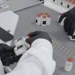In this undated image from video provided by Regeneron Pharmaceuticals on Friday, Oct. 2, 2020, vials are inspected at the company's facilities in New York state, for efforts on an experimental coronavirus antibody drug. Antibodies are proteins the body makes when an infection occurs; they attach to a virus and help the immune system eliminate it. (Regeneron via AP)