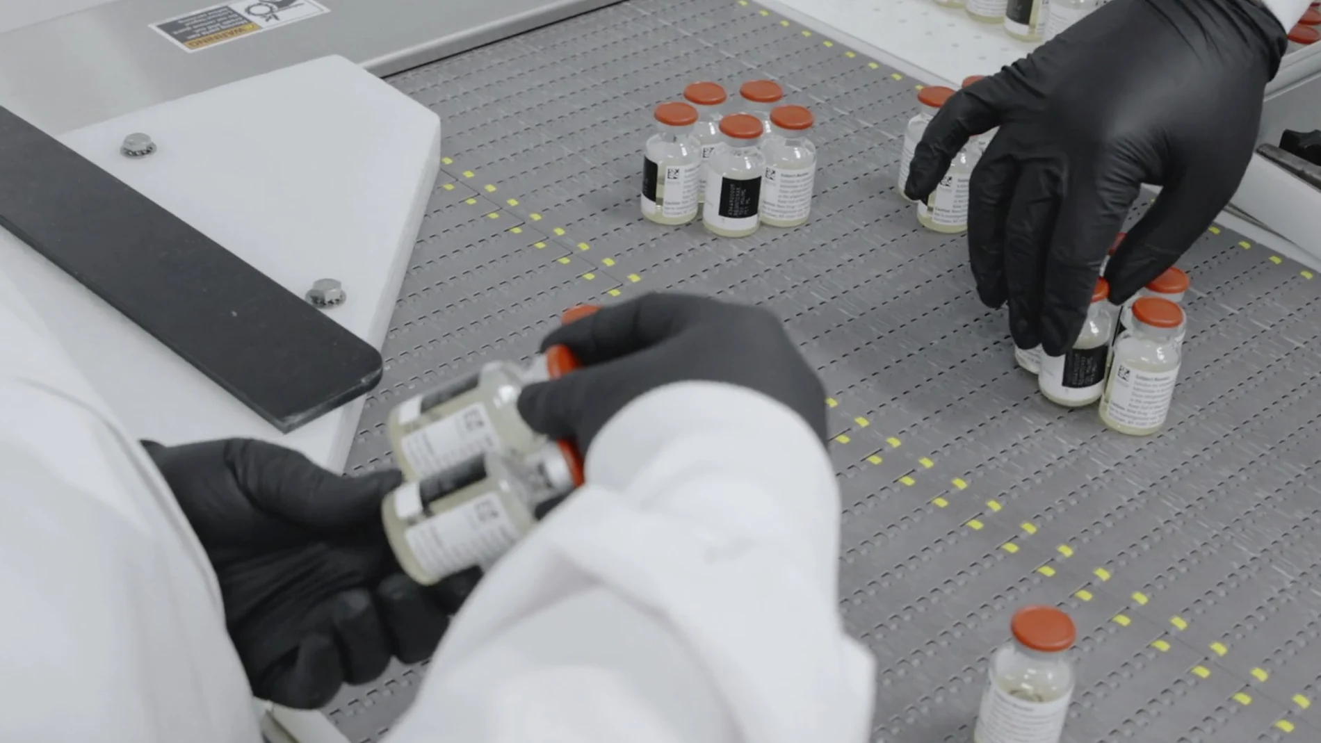 In this undated image from video provided by Regeneron Pharmaceuticals on Friday, Oct. 2, 2020, vials are inspected at the company's facilities in New York state, for efforts on an experimental coronavirus antibody drug. Antibodies are proteins the body makes when an infection occurs; they attach to a virus and help the immune system eliminate it. (Regeneron via AP)
