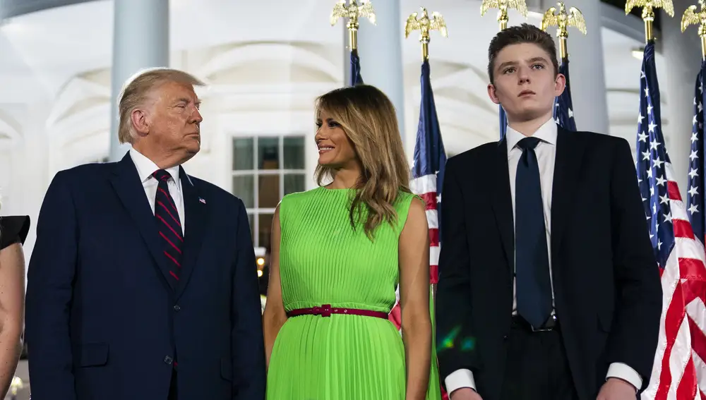 FILE - In this Aug. 27, 2020 file photo, Barron Trump right, stands with President Donald Trump and first lady Melania Trump on the South Lawn of the White House on the fourth day of the Republican National Convention in Washington. (AP Photo/Evan Vucci)