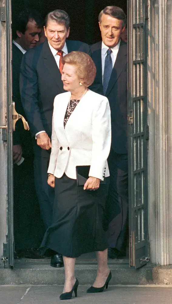 Former U.S. President Ronald Reagan (L) and former Canadian Prime Minister Brian Mulroney (R) follow former British Prime Minister Margaret Thatcher (C) through a door as they walk to the group photo at the annual G7 Summit in Toronto in this June 1988 file photo. Reagan passed away at the age of 93, June 6, 2004. REUTERS/FILES/Gary Hershorn