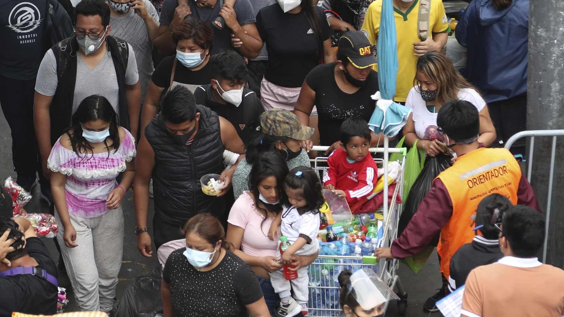 Pedestrians wearing face masks amid the COVID-19 pandemic walk in the Mesa Redonda Market, a popular spot for Christmas shopping in Lima, Peru, Friday, Dec. 18, 2020. Peru's Health Ministry has announced on Tuesday, Dec. 22, that it has surpassed 1 million confirmed cases of the new coronavirus. (AP Photo/Martin Mejia, File)