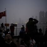 Chinos con mascarilla atraviesan en barco el río Yangtsé
