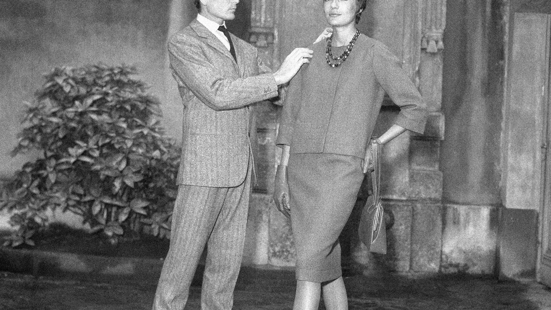 FILE - In this Sept.13, 1960 file photo, Parisian designer Pierre Cardin, with one of his models, shows the new uniform he has created for the hostesses of French television in Paris. France's Academy of Fine Arts says famed fashion designer Pierre Cardin has died at 98 (AP Photo/Pierre Godot, File)