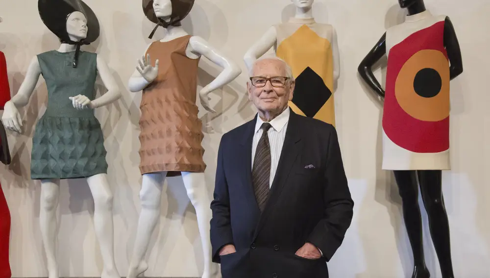 FILE - In this Nov.13, 2014 file photo, French fashion designer Pierre Cardin poses with dresses behind during the inauguration of the Pierre Cardin Museum in Paris. France's Academy of Fine Arts says Pierre Cardin, the French designer whose Space Age style was among the iconic looks of 20th-century fashion, has died at 98. (AP Photo/Jacques Brinon, File)