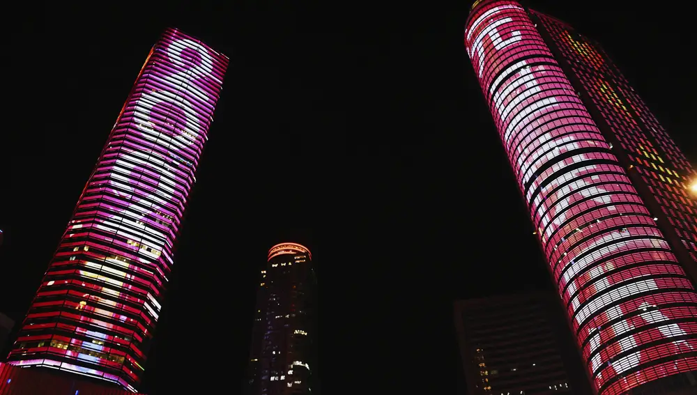 &quot;2021&quot; and &quot;Happy New Year&quot; are displayed on the sides of buildings in Nanjing on New Year's Eve in eastern China's Jiangsu Province, Thursday, Dec. 31, 2020. This New Year's Eve is being celebrated like no other, with pandemic restrictions limiting crowds and many people bidding farewell to a year they'd prefer to forget. (Chinatopix via AP)