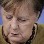 Germany's Chancellor Angela Merkel takes part in a press conference following the consultations between the federal and state governments on further COVID measures, in Berlin, Tuesday, Jan. 5, 2021. (Michael Kappeler/pool photo via AP)