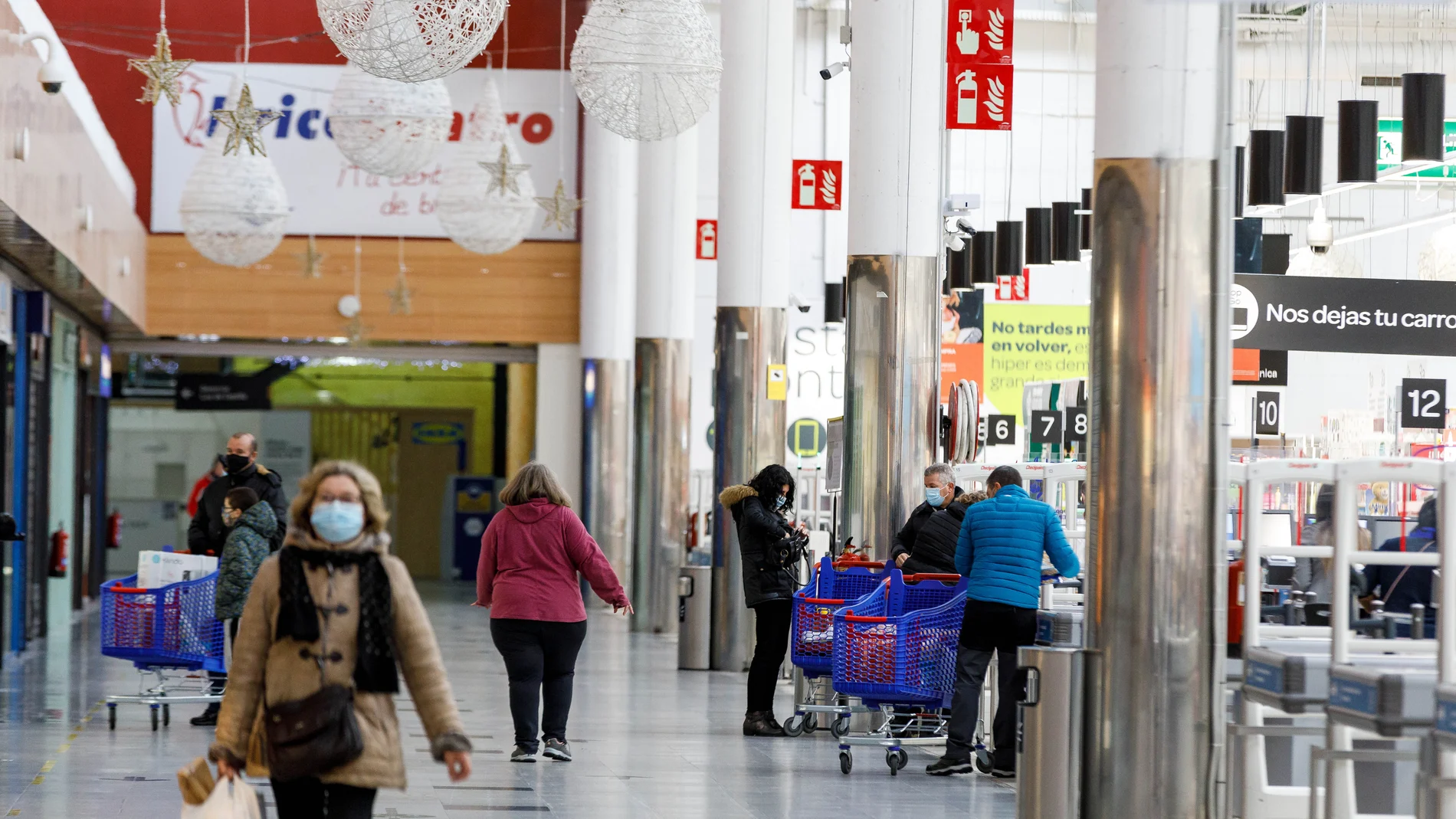 Varias personas hacen compras en un centro comercial de Segovia