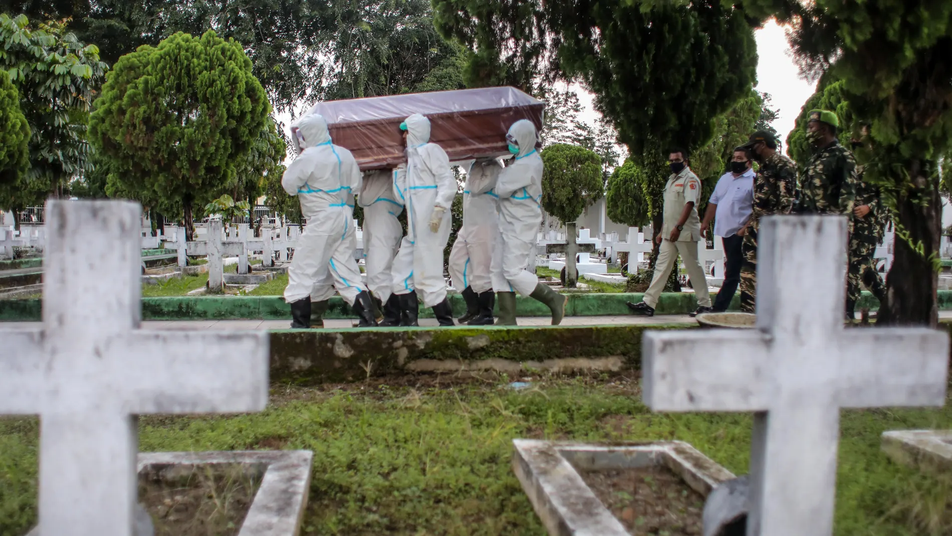 Trabajadores funerarios transporta un féretro en Indonesia