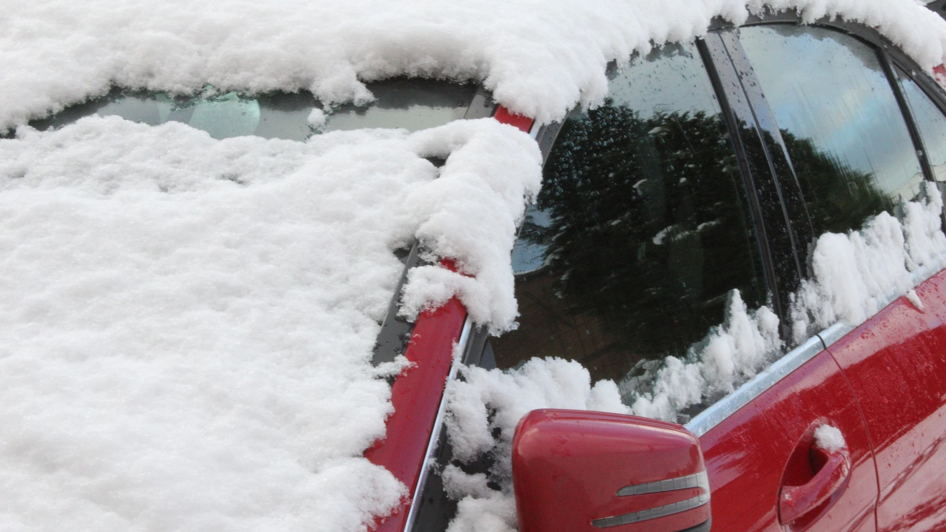 Un coche cubierto con una capa de nieve