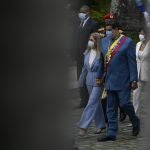 Accompanied by first lady Cilia Flores, left, Venezuelan President Nicolas Maduro arrives to give his annual address to the nation before lawmakers at the National Assembly in Caracas, Venezuela, Tuesday, Jan. 12, 2021. (AP Photo/Matias Delacroix)
