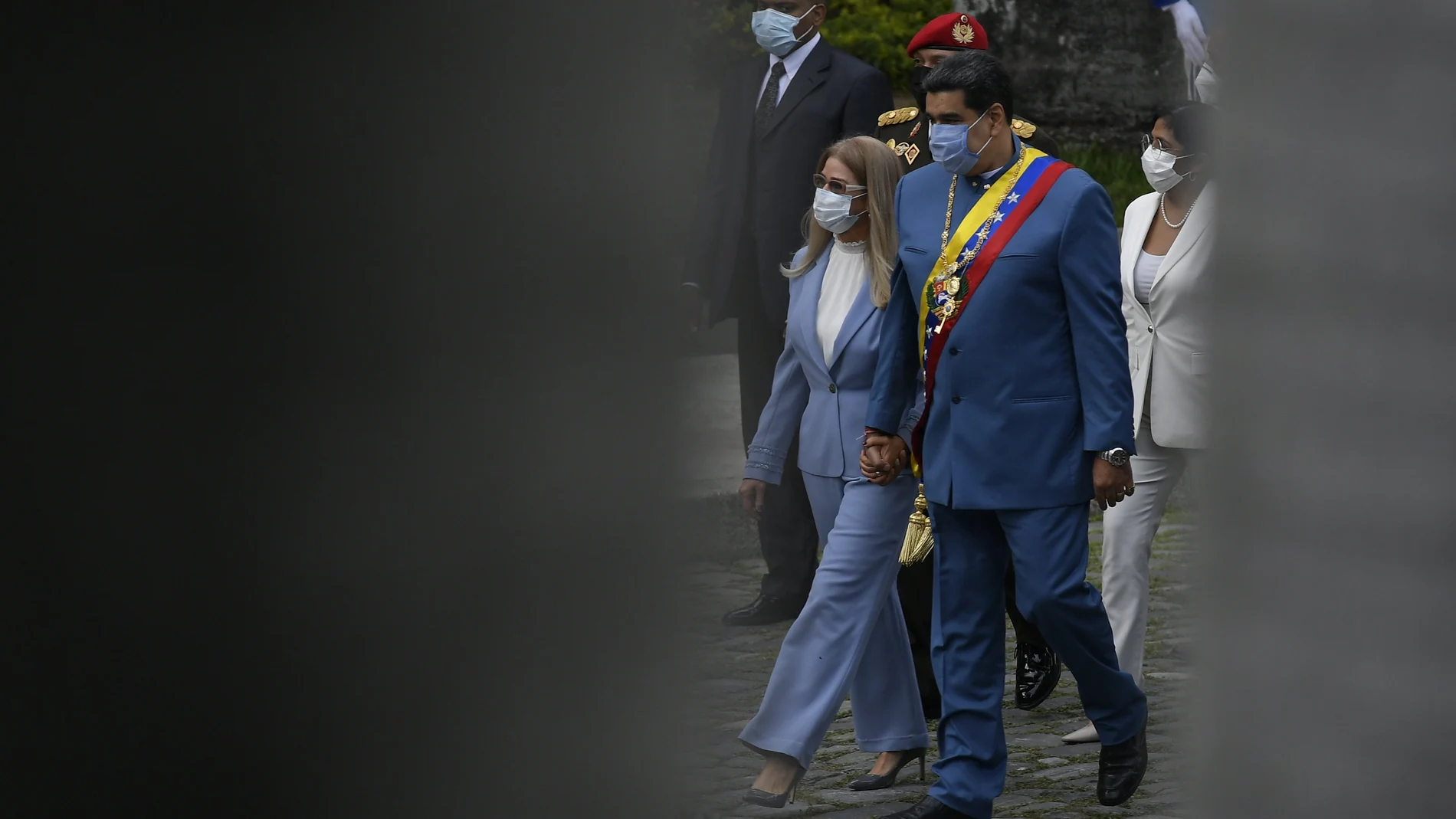 Accompanied by first lady Cilia Flores, left, Venezuelan President Nicolas Maduro arrives to give his annual address to the nation before lawmakers at the National Assembly in Caracas, Venezuela, Tuesday, Jan. 12, 2021. (AP Photo/Matias Delacroix)