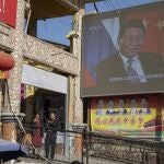 Chinese President Xi Jinping is seen on a screen near a bazaar in Hotan in western China's Xinjiang region, China, Friday, Nov. 3, 2017. The accusation of genocide by U.S. Secretary of State Mike Pompeo against China touches on a hot-button human rights issue between China and the West. (AP Photo/Ng Han Guan)