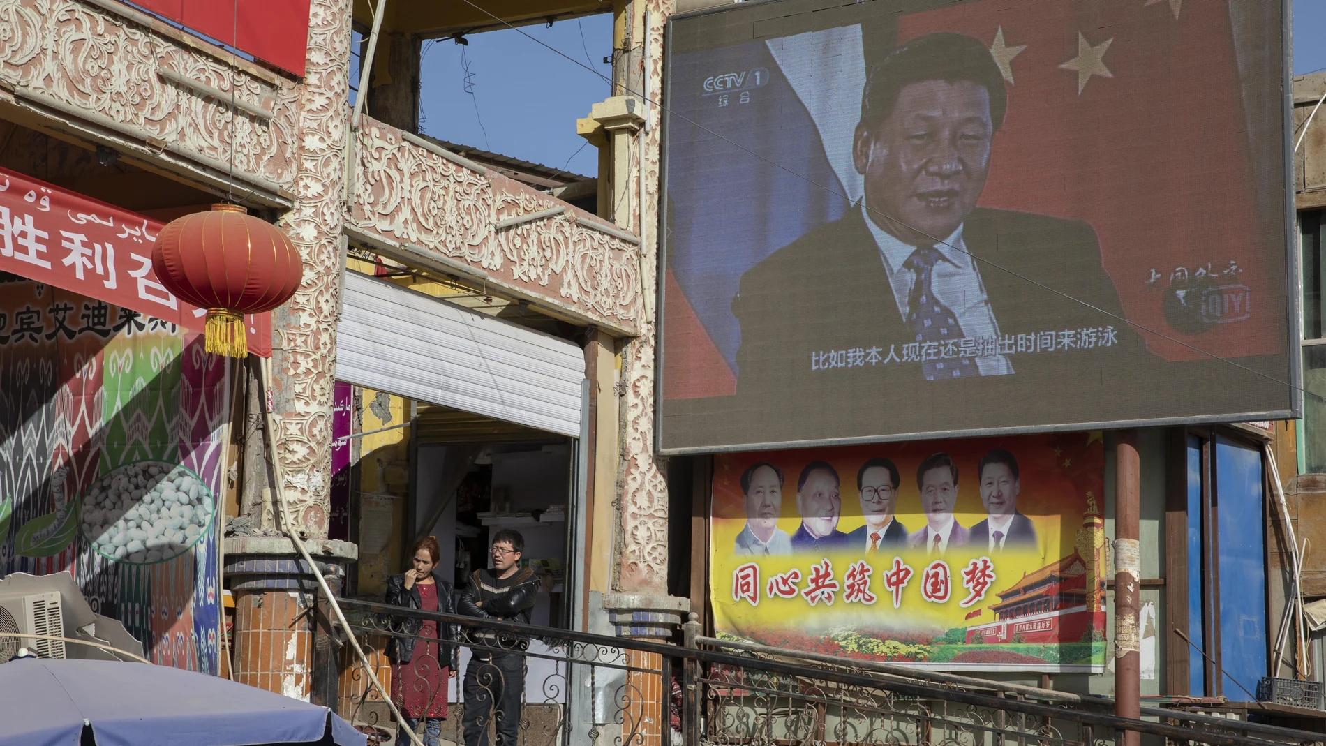 Chinese President Xi Jinping is seen on a screen near a bazaar in Hotan in western China's Xinjiang region, China, Friday, Nov. 3, 2017. The accusation of genocide by U.S. Secretary of State Mike Pompeo against China touches on a hot-button human rights issue between China and the West. (AP Photo/Ng Han Guan)
