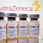 FILE PHOTO: Vials with a sticker reading, "COVID-19 / Coronavirus vaccine / Injection only" and a medical syringe are seen in front of a displayed AstraZeneca logo in this illustration taken October 31, 2020. REUTERS/Dado Ruvic/Illustration/File Photo