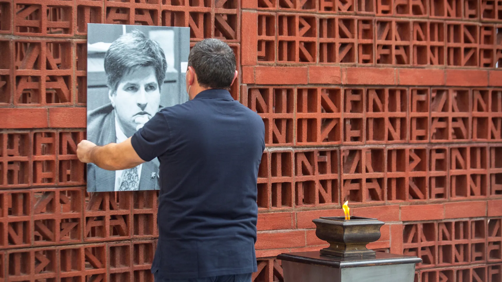 Un operario del Parlamento Vasco coloca un retrato de Gregorio Ordóñez en la sede de la institución en Vitoria el pasado enero