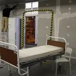 Un trabajador termina un muro recién construido en el comedor del Hospital Militar en Lisboa que se está transformando en una sala de 50 camas