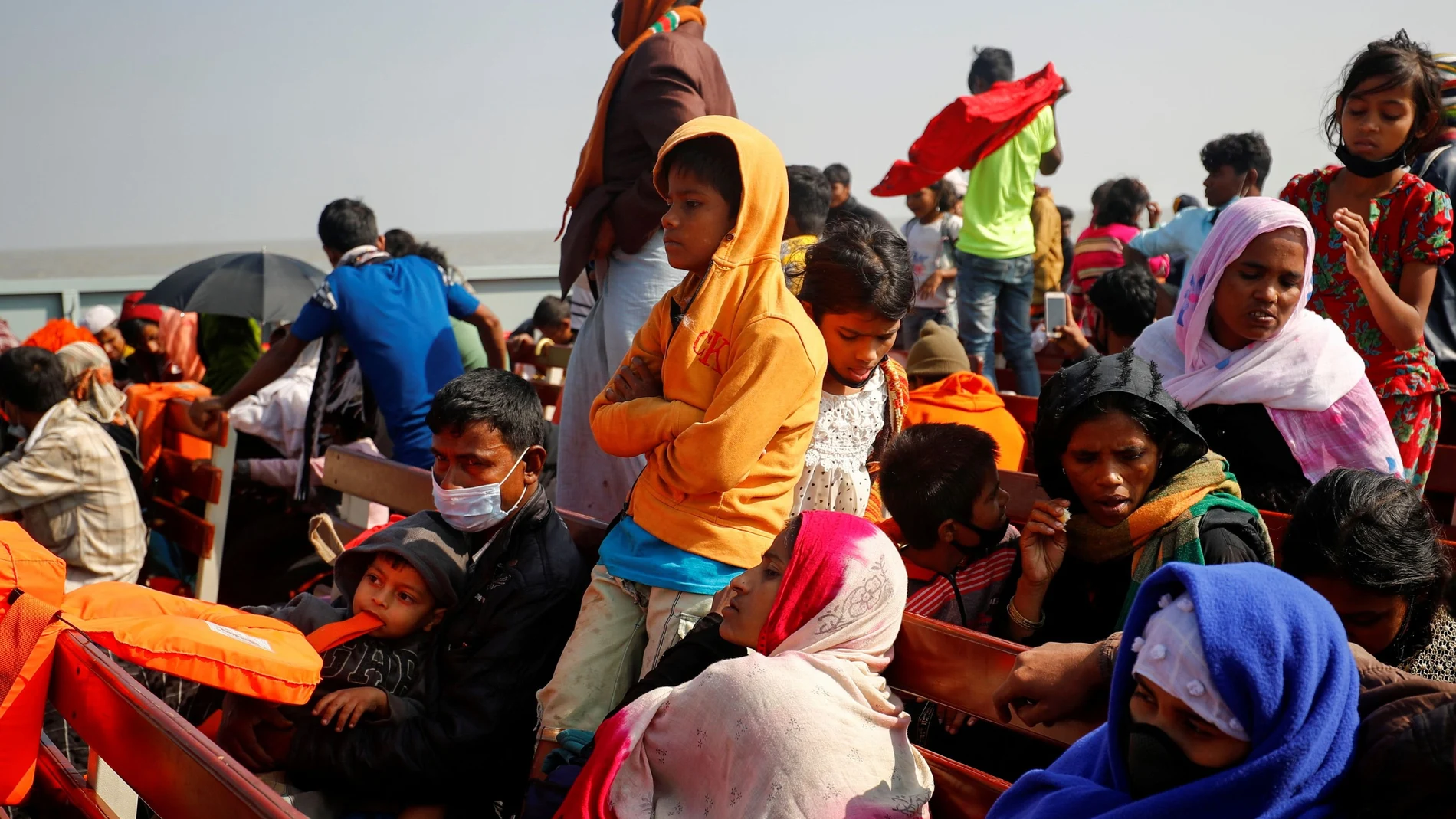 FILE PHOTO: Rohingya refugees sit on wooden benches of a navy vessel on their way to the Bhasan Char island in Noakhali district, Bangladesh, December 29, 2020. REUTERS/Mohammad Ponir Hossain/File Photo
