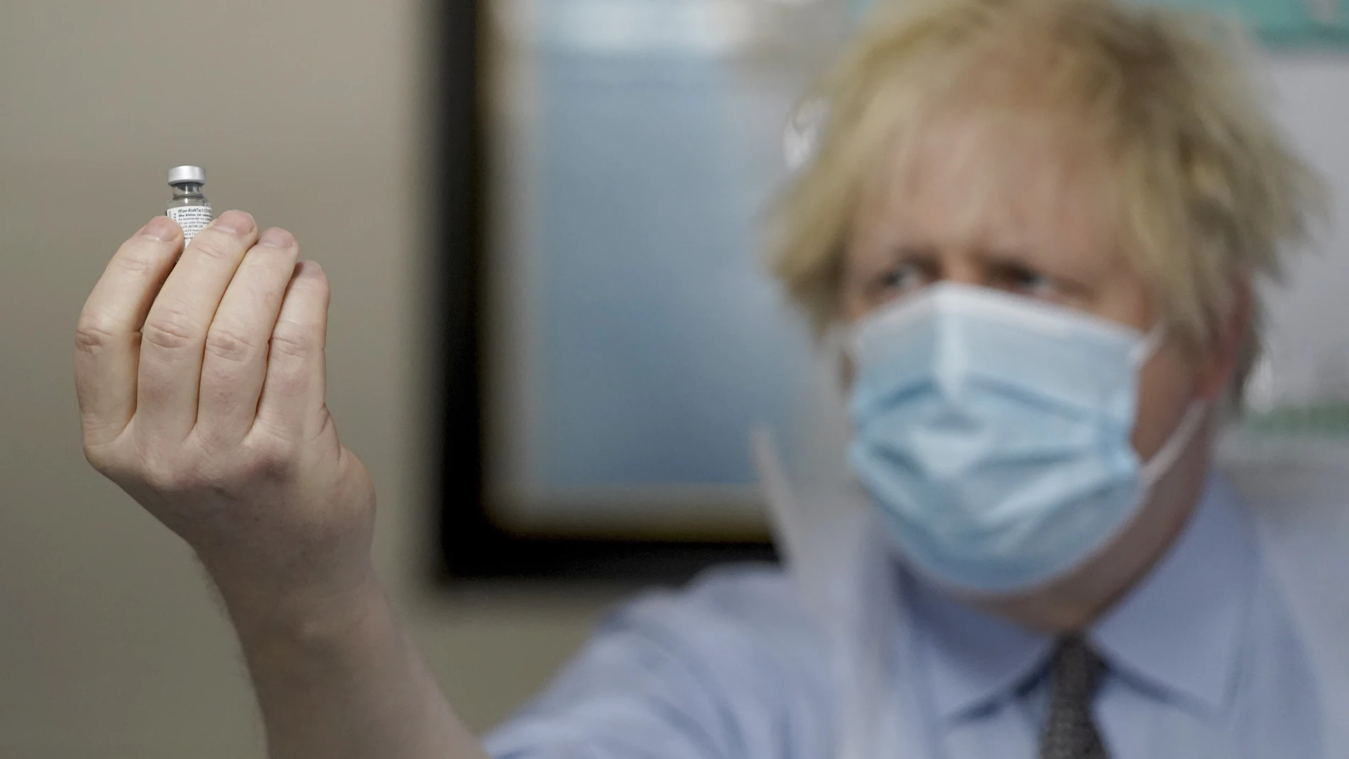 Boris Johnson sostiene un vial con la vacuna del coronavirus