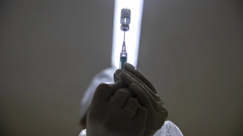 FILE - In this Wednesday, Dec. 30, 2020 file photo, a medical worker prepares a shot of Russia's Sputnik V coronavirus vaccine in Moscow, Russia. Russian scientists say the country's Sputnik V vaccine appears safe and effective against COVID-19, according to early results of an advanced study published on Tuesday Feb. 2, 2021, in a British medical journal. (AP Photo/Pavel Golovkin, File)