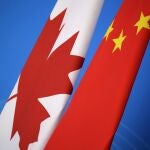 In this Nov. 12, 2018, file photo, flags of Canada and China are placed for the first China-Canada economic and financial strategy dialogue in Beijing, China. China says it has lodged a formal complaint with Canada over T-shirts ordered by one of the countryâ€™s Beijing Embassy staff that allegedly mocked Chinaâ€™s response to the coronavirus outbreak. (Jason Lee/Pool Photo via AP, File)