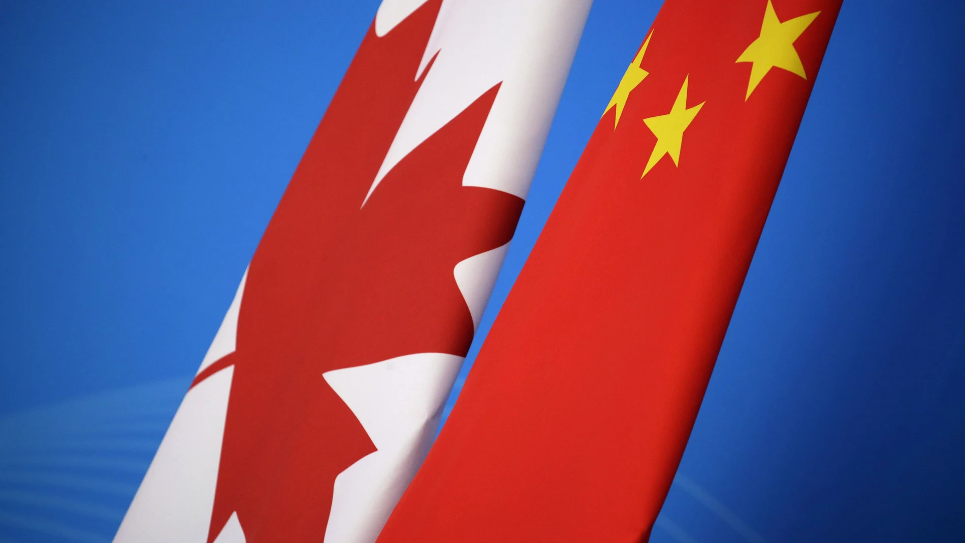 In this Nov. 12, 2018, file photo, flags of Canada and China are placed for the first China-Canada economic and financial strategy dialogue in Beijing, China. China says it has lodged a formal complaint with Canada over T-shirts ordered by one of the countryâ€™s Beijing Embassy staff that allegedly mocked Chinaâ€™s response to the coronavirus outbreak. (Jason Lee/Pool Photo via AP, File)