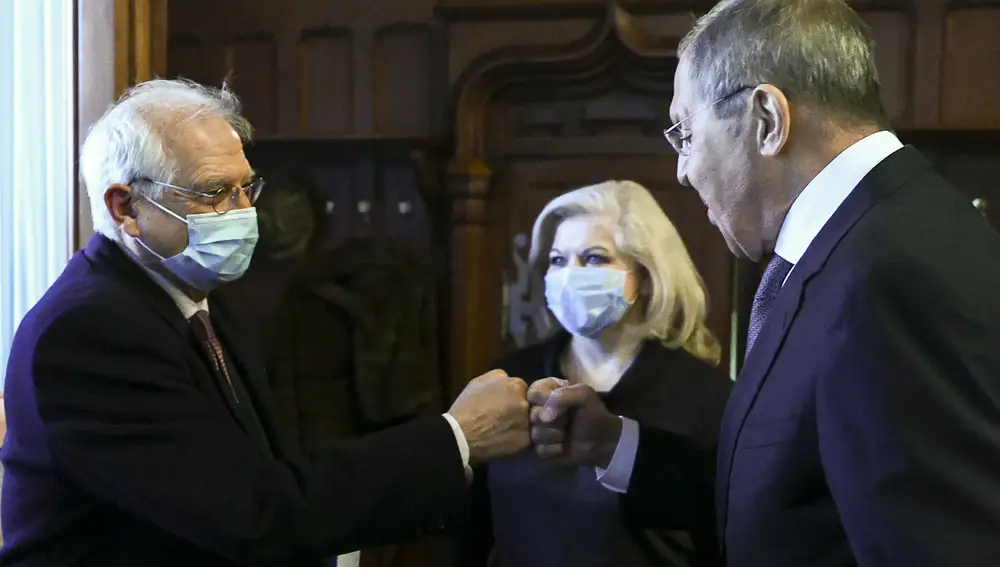In this photo released by the Russian Foreign Ministry Press Service, Russian Foreign Minister Sergey Lavrov, right, and High Representative of the EU for Foreign Affairs and Security Policy Josep Borrell wearing a face mask to protect against coronavirus, greet each other prior to their talks in Moscow, Russia, Friday, Feb. 5, 2021. The European Union's top diplomat expressed hopes Friday that the COVID-19 vaccine developed by Russia will soon be used across the 27-nation bloc. During a visit to Moscow, EU foreign affairs chief Josep Borrell said the Sputnik V vaccine is &quot;good news for the whole mankind.&quot; (Russian Foreign Ministry Press Service via AP)