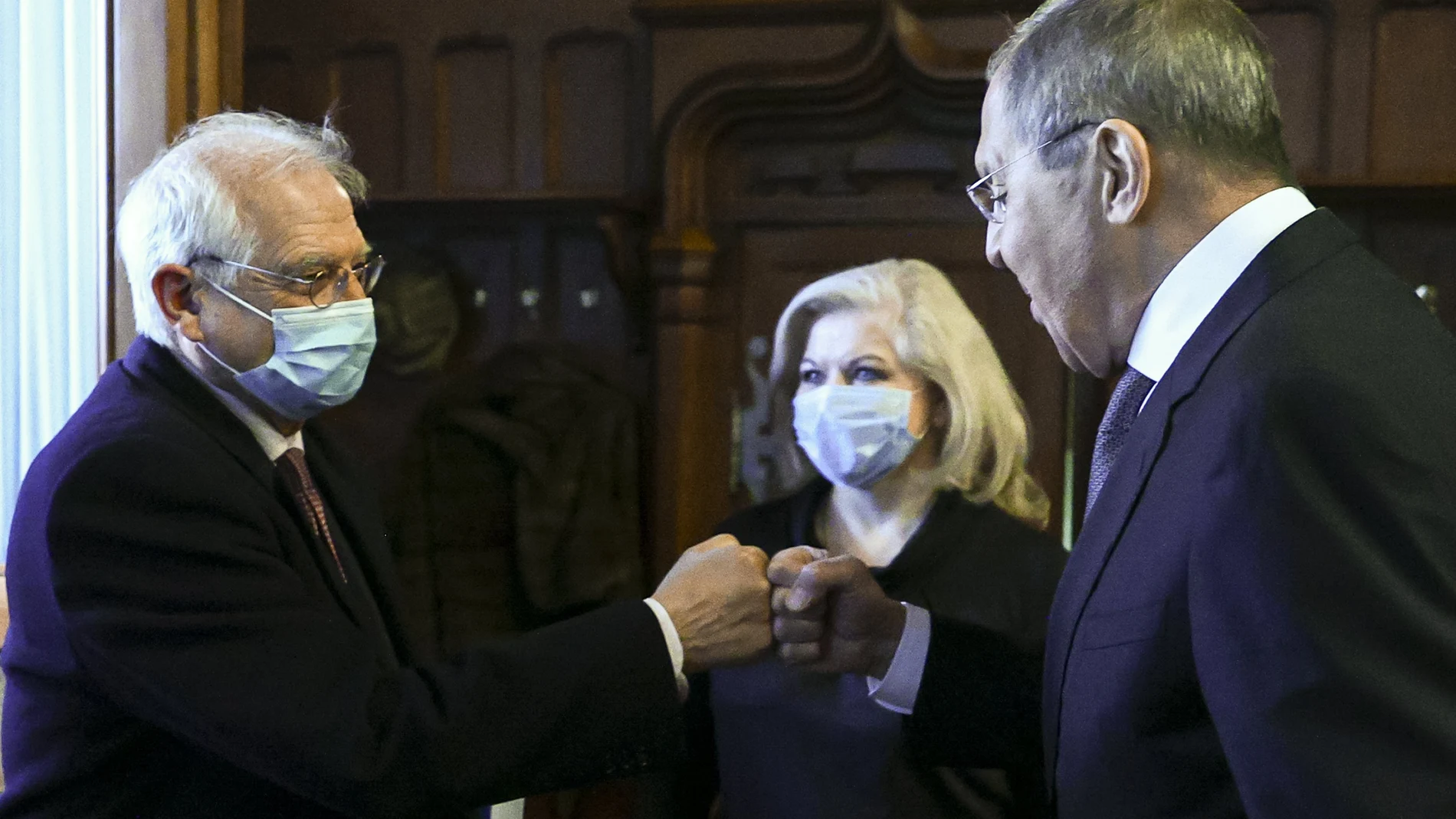 In this photo released by the Russian Foreign Ministry Press Service, Russian Foreign Minister Sergey Lavrov, right, and High Representative of the EU for Foreign Affairs and Security Policy Josep Borrell wearing a face mask to protect against coronavirus, greet each other prior to their talks in Moscow, Russia, Friday, Feb. 5, 2021. The European Union's top diplomat expressed hopes Friday that the COVID-19 vaccine developed by Russia will soon be used across the 27-nation bloc. During a visit to Moscow, EU foreign affairs chief Josep Borrell said the Sputnik V vaccine is "good news for the whole mankind." (Russian Foreign Ministry Press Service via AP)
