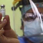 A doctor shows a vial of China's Sinopharm vaccine for COVID-19 before giving shots to healthworkers at a public hospital in Lima, Peru, Tuesday, Feb. 9, 2021. Peru received its first shipment of COVID-19 vaccines on Sunday night. (AP Photo/Martin Mejia)