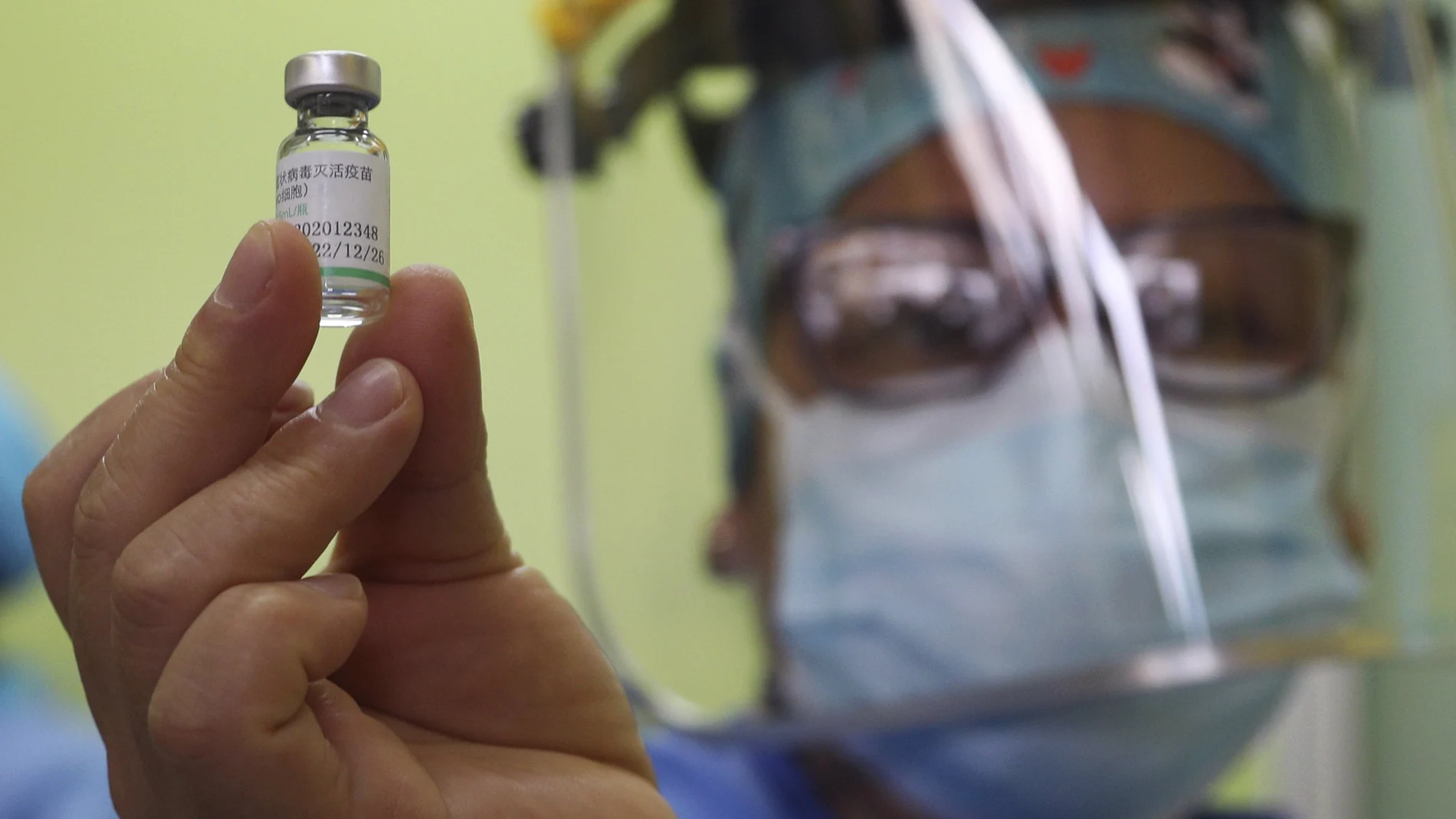 A doctor shows a vial of China's Sinopharm vaccine for COVID-19 before giving shots to healthworkers at a public hospital in Lima, Peru, Tuesday, Feb. 9, 2021. Peru received its first shipment of COVID-19 vaccines on Sunday night. (AP Photo/Martin Mejia)