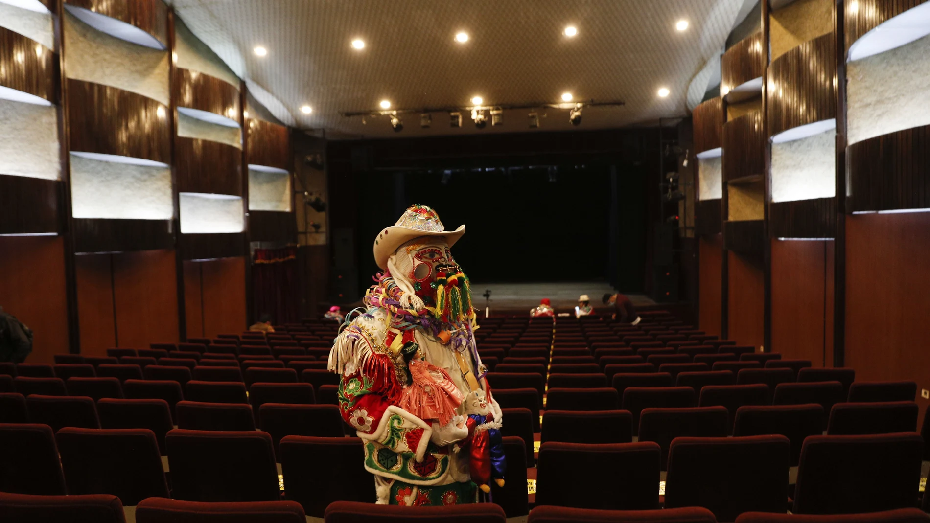 A man dressed as a Chuta arrives to participate in the election of the three main beloved Carnival characters: Chuta, Pepino and Chola, all of whom represent gaiety in La Paz, Bolivia, Monday, Feb. 8, 2021. The winning trio of Carnival must be adept at spreading happiness and never tire of dancing, however due to the COVID-19 pandemic, their performances will be broadcast online. (AP Photo/Juan Karita)